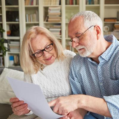 Elderly couple reviewing a document together