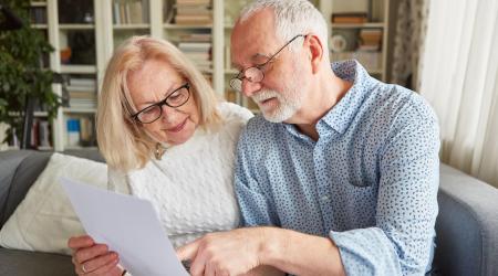Elderly couple reviewing a document together