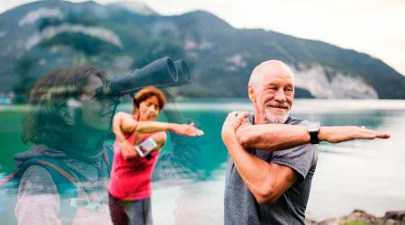 A couple exercising outdoors, surrounded by breathtaking natural beauty with a serene lake in the background.