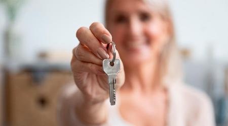 Woman shows key of her new house